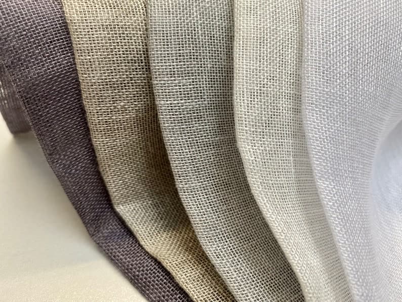 Close-up texture of handloom linen fabric showing natural slubs
